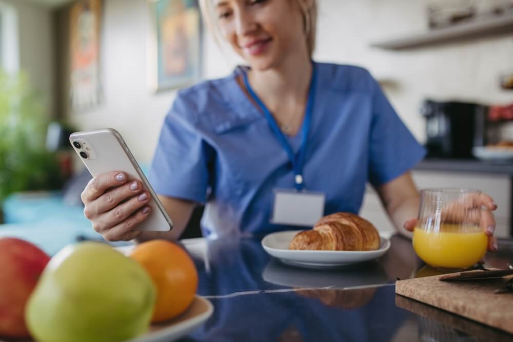 Healthcare worker having healthy breakfast at home, work-life balance for healthcare worker