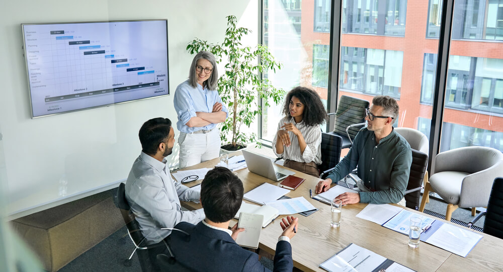 a happy team leader in a meeting with team members